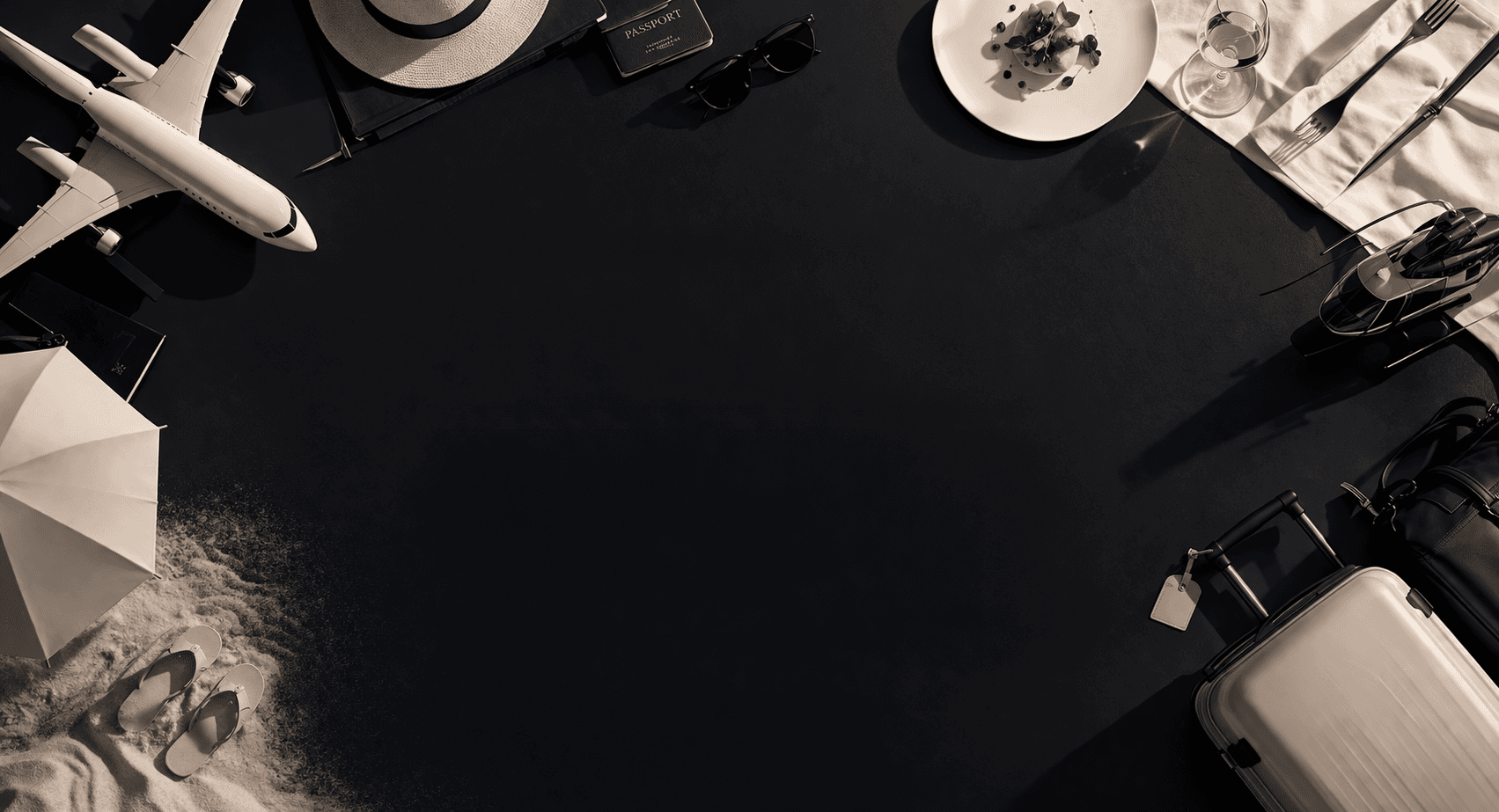 Luxury travel objects arranged around a dark tabletop